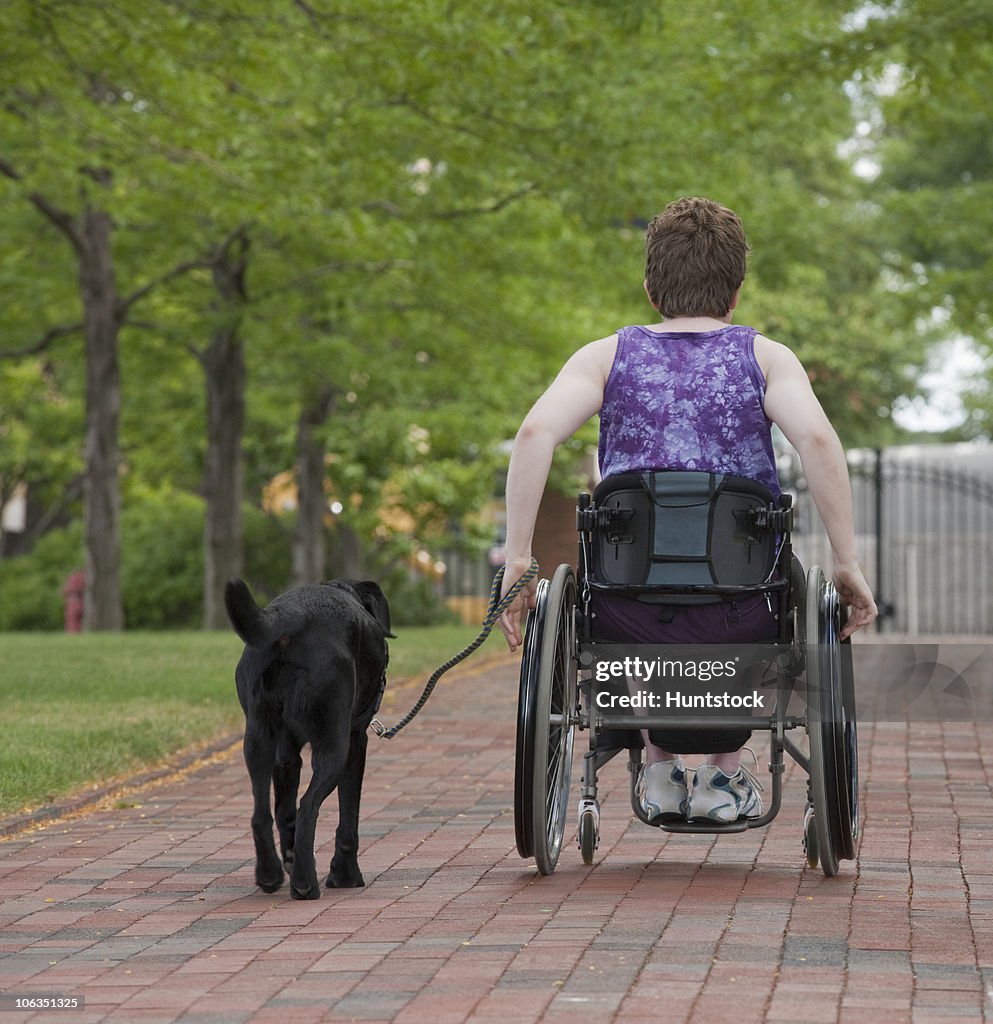 Woman with Multiple Sclerosis in a park with a service dog