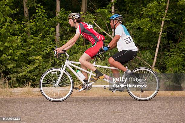 tandem disability racers with pilot in front and blind man - blind man stockfoto's en -beelden