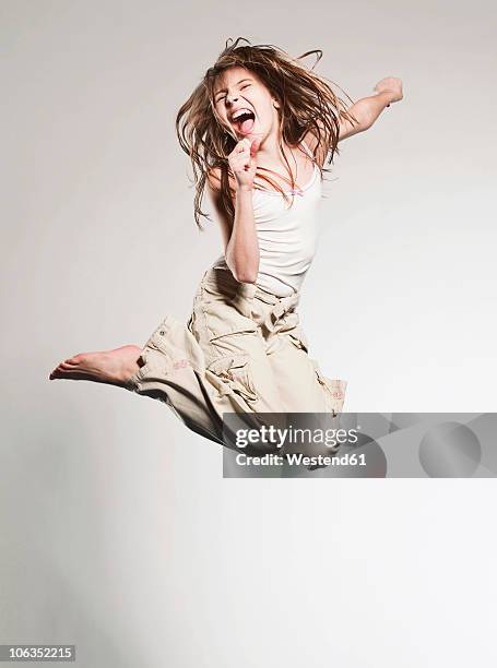 girl (10-11) jumping and singing - girl singing stock pictures, royalty-free photos & images