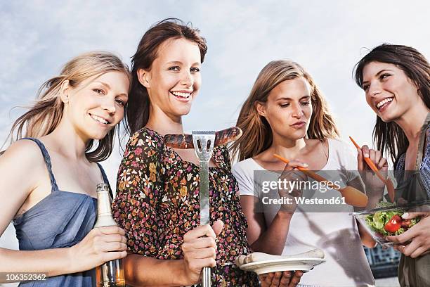 germany, cologne, women enjoying beer and sausages - beer bottle mouth stock pictures, royalty-free photos & images