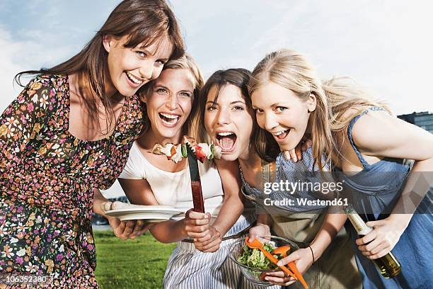 germany, cologne, women enjoying beer and sausages - beer bottle mouth stock pictures, royalty-free photos & images