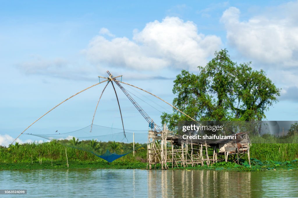 Traditional fishing nets made from bamboo and wood over sunrise at lake Thale Noi, Phatthalung, Thailand.