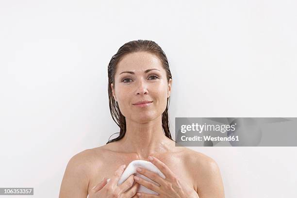 germany, woman in bathroom holding towel, smiling - older woman wet hair stock pictures, royalty-free photos & images