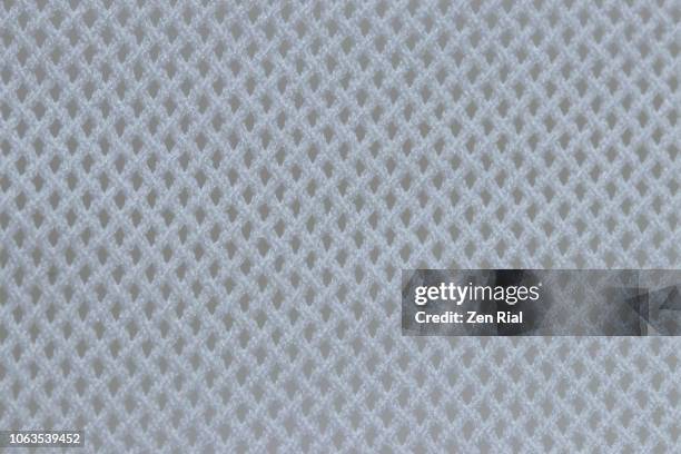 macro image of a white mesh textile - netz textilien stock-fotos und bilder