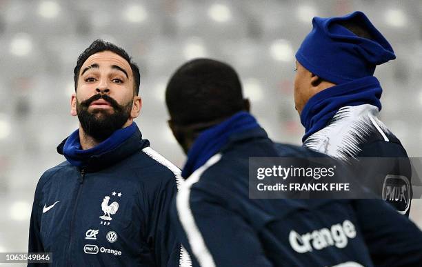 France's defender Adil Rami takes part in a training session at the Stade de France stadium in Saint-Denis, north of Paris, on November 19, 2018 on...