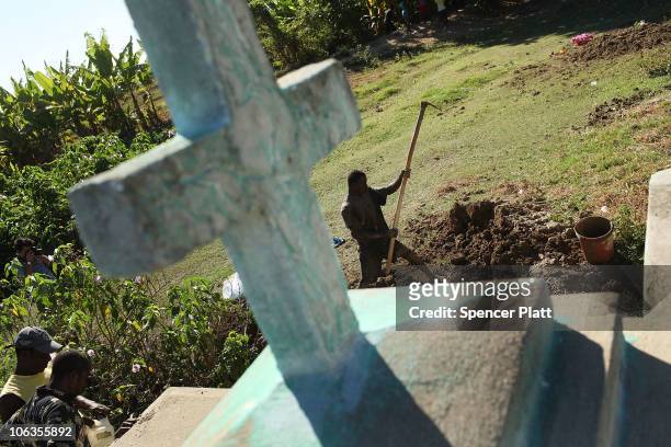 Cemetery workers cover the grave of Serette Pierre, who recently died of cholera October 29, 2010 in Back D' Aguin, Haiti. Pierre died the same day...