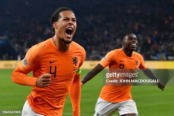 Netherlands' defender Virgil van Dijk celebrates scoring the 2-2 with Netherlands' forward Quincy Promes during the UEFA Nations League football...