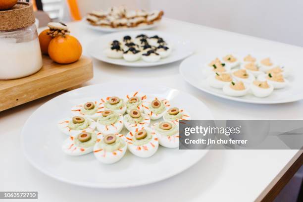 three kinds of deviled eggs - deviled eggs halloween stock pictures, royalty-free photos & images