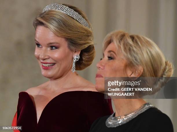 Belgium's Queen Mathilde and French President's wife Brigitte Macron welcome guests for a state dinner at the Royal Palace in Laeken, Belgium on...