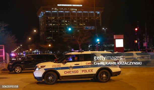 Chicago Police officers monitor the area outside of the Chicago Mercy Hospital where a gunman opened fire in Chicago on November 19, 2018. - An...