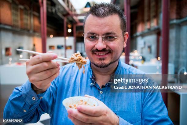 Andreas Ahrens, curator and museum director of the Disgusting Food Museum, poses for a picture with Natto, fermented soybeans from Japan, presented...