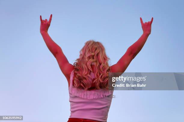 Cheerleader for the Texas Longhorns shows her 'hook 'em horns' before a game against the Oklahoma State Cowboys on October 27, 2018 at Boone Pickens...