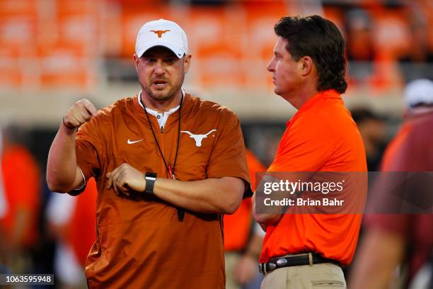 Head coach Tom Herman of the Texas Longhorns talks with head coach Mike Gundy of the Oklahoma State Cowboys on October 27, 2018 at Boone Pickens...