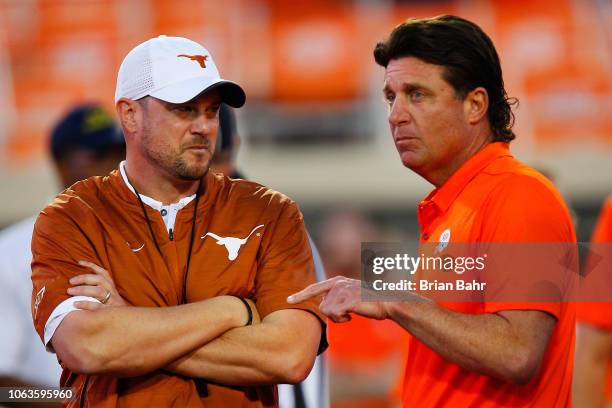 Head coach Tom Herman of the Texas Longhorns talks with head coach Mike Gundy of the Oklahoma State Cowboys on October 27, 2018 at Boone Pickens...