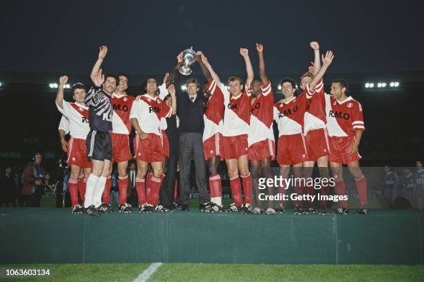 Monaco manager Arsene Wenger lifts the trophy with striker George Weah after Monaco had beaten Marseille in the 1991 Coupe de France Cup Final at...