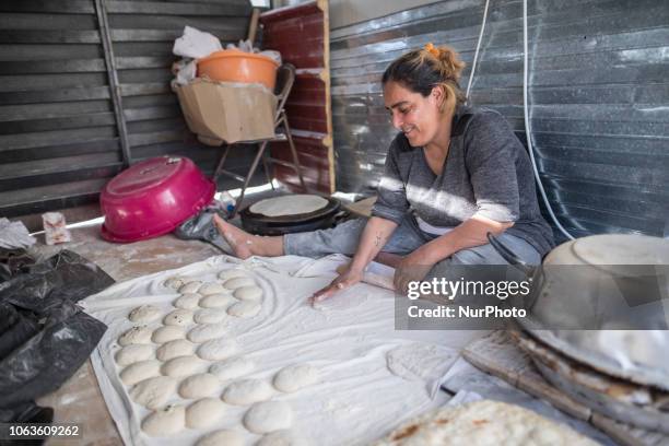 Refugee woman makes naan a kind of a flatbread in Diavata - Anagnostopoulou refugee camp, near Thessaloniki in Greece. Refugees prefer to create...