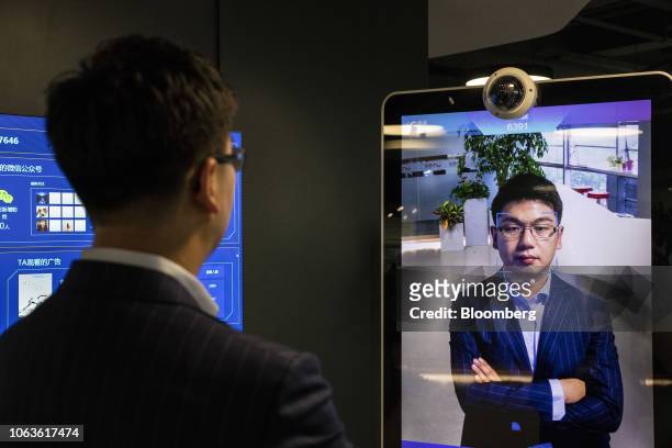 Xu Li, chief executive officer of SenseTime Group Ltd., is identified by the company's facial recognition system on a screen as he poses for a...