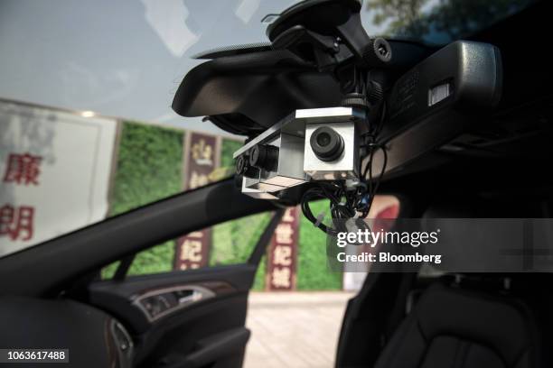 Cameras for SenseTime Group Ltd.'s autonomous driving system are mounted inside a Lincoln Motor Co. MKZ sedan during a test-drive in Hangzhou, China,...