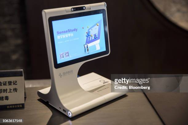 Sedi Technology Co. Device equipped with SenseTime Group Ltd.'s facial recognition technology stands at the check-in counter of a hotel in Hangzhou,...