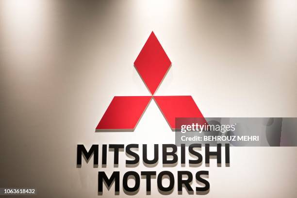 The logo of Mitsubishi Motors is seen at the company's headquarters in Tokyo on November 20, 2018. Nissan and Mitsubishi shares plunged on November...