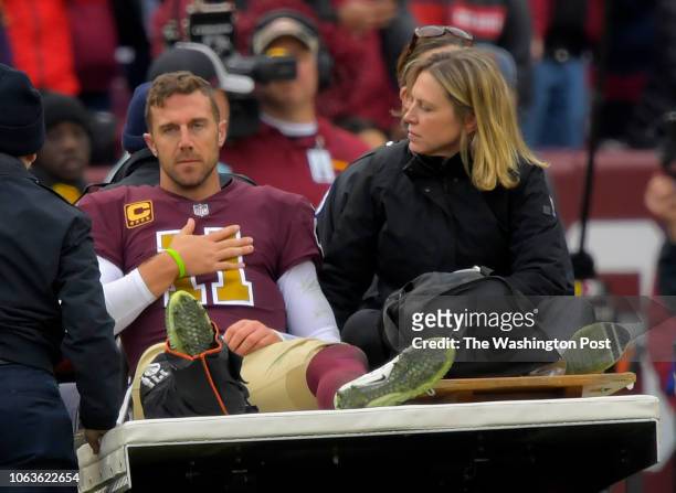 Washington Redskins quarterback Alex Smith is carted off the field in the 3rd quarter after breaking his right leg during a game between the...
