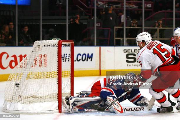 Tuomo Ruutu of the Carolina Hurricanes scores a goal against Henrik Lundvist of the New York Rangers in the first period on October 29, 2010 at...