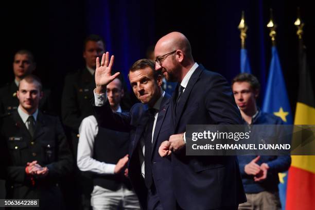 Belgian Prime Minister Charles Michel and French President Emmanuel Macron leave the stage at the end of their visit at the University of Louvain on...