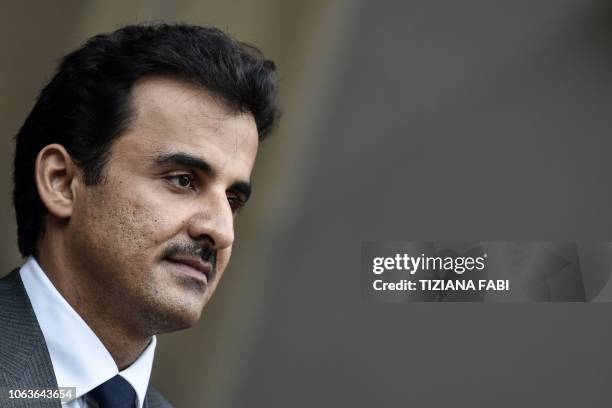 Qatar's Sheikh Tamim bin Hamad al-Thani stands at attention upon his arrival for a meeting with Italys prime minister at Villa Phamphili in Rome on...