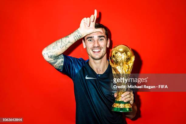 Antoine Griezmann of France poses with the Champions World Cup trophy after the 2018 FIFA World Cup Russia Final between France and Croatia at...