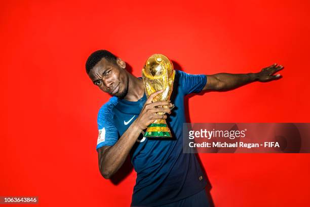 Paul Pogba of France poses with the Champions World Cup trophy after the 2018 FIFA World Cup Russia Final between France and Croatia at Luzhniki...