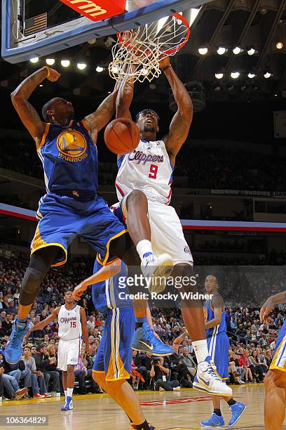 DeAndre Jordan of the Los Angeles Clippers dunks the ball over Dorell Wright of the Golden State Warriors on October 29, 2010 at Oracle Arena in...