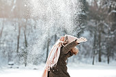 Beautiful young woman enjoying in the snow