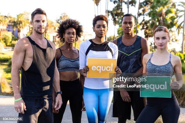 group of different ethnicities people standing for equal rights and justice - wage gap stock pictures, royalty-free photos & images