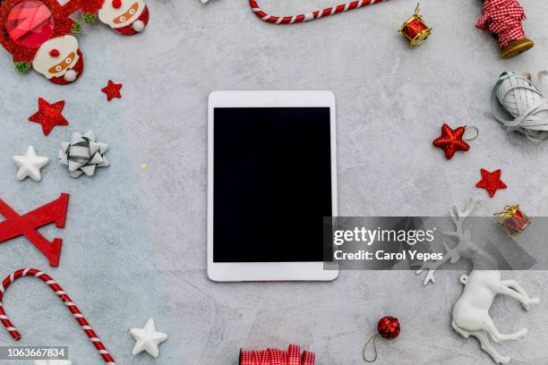 xmas items and digital tablet. top view.red background - ipad white background stock pictures, royalty-free photos & images