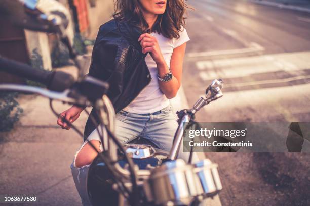 young pretty fashioned girl sitting on her motorcycle - biker jacket stock pictures, royalty-free photos & images