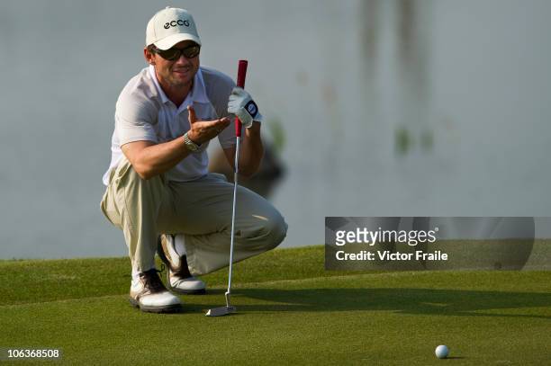 Hollywood actor Christian Slater of USA lines a putt on the 17th green during day four of the Mission Hills Start Trophy tournament at Mission Hills...