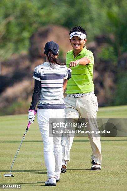 Golfer Ryuji Imada of Japan celebrate his shot with Actor Ai Katoh of Japan during day four of the Mission Hills Start Trophy tournament at Mission...