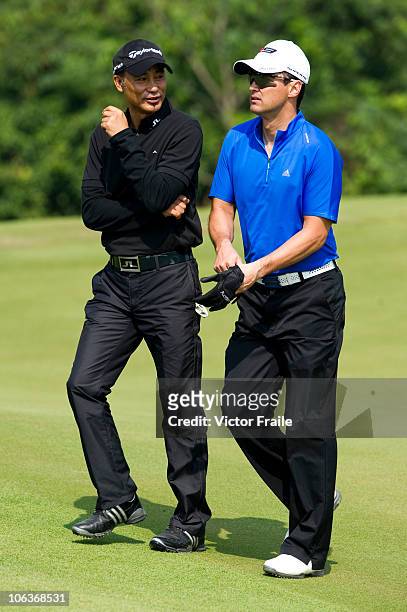 Hong Kong actors Simon Yam and Michael Wong talk on the 5th green during day four of the Mission Hills Start Trophy tournament at Mission Hills...
