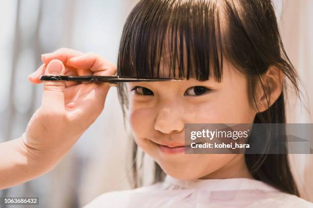 girl having her hair cut by beautician - cutting hair stock pictures, royalty-free photos & images