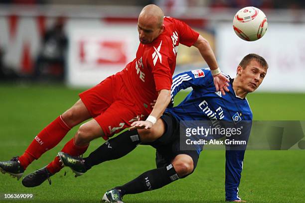 Miso Brecko of Koeln is challenged by Robert Tesche of Hamburg during the Bundesliga match between 1 FC Koeln and Hamburger SV at the...