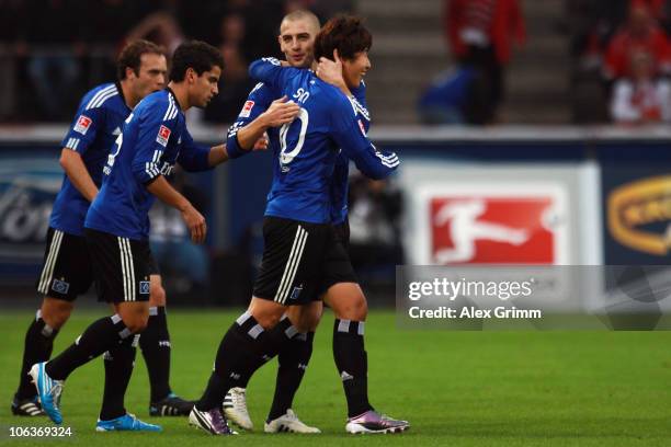 Heung-Min Son of Hamburg celebrates his team's second goal with team mates Mladen Petric, Tomas Rincon and Joris Mathijsen during the Bundesliga...