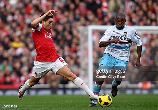 Samir Nasri of Arsenal fights for the ball with Luis Boa Morte of West Ham during the Barclays Premier League match between Arsenal and West Ham...