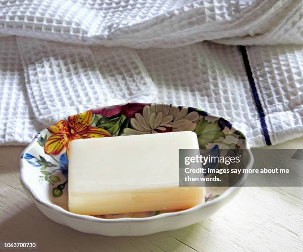 a bar of soap, a soap dish and a bath robe. close up. - saboneteira imagens e fotografias de stock