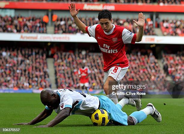 Samir Nasri of Arsenal fights for the ball with Herita Ilunga of West Ham during the Barclays Premier League match between Arsenal and West Ham...