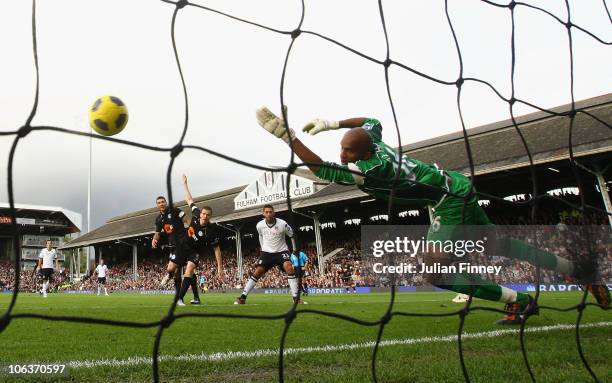 Clint Dempsey of Fulham scores his frist goal with a header past Wigan Goalkeeper, Ali Al Habsi during the Barclays Premier League match between...