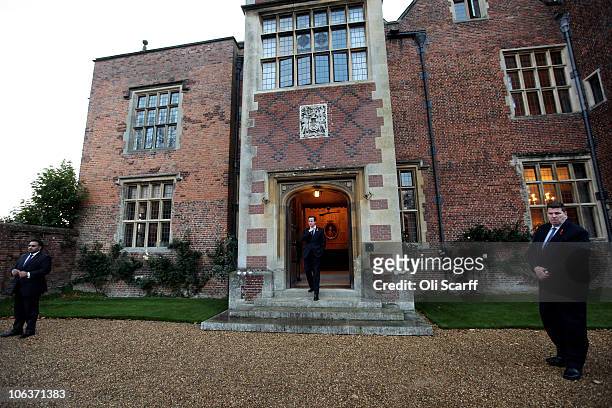 British Prime Minster David Cameron waits to greet the German Chancellor Angela Merkel outside Chequers, the Prime Minister's country residence on...