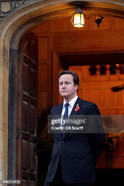 British Prime Minster David Cameron waits to greet the German Chancellor Angela Merkel outside Chequers, the Prime Minister's country residence on...