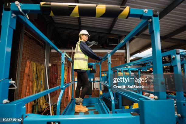trainee mechanic working on a cherry picker - cherry picker stock pictures, royalty-free photos & images
