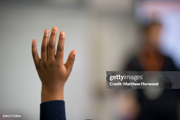 Child holds their hand up in classroom on June 28, 2018 in Cardiff, United Kingdom.