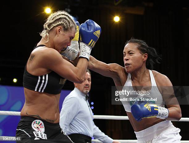 Mikaela Lauren of Sweden and Cecilia Braekhus of Norway exchange punches during their WBC WBA WBO Female Welterweight title fight at Stadthalle...